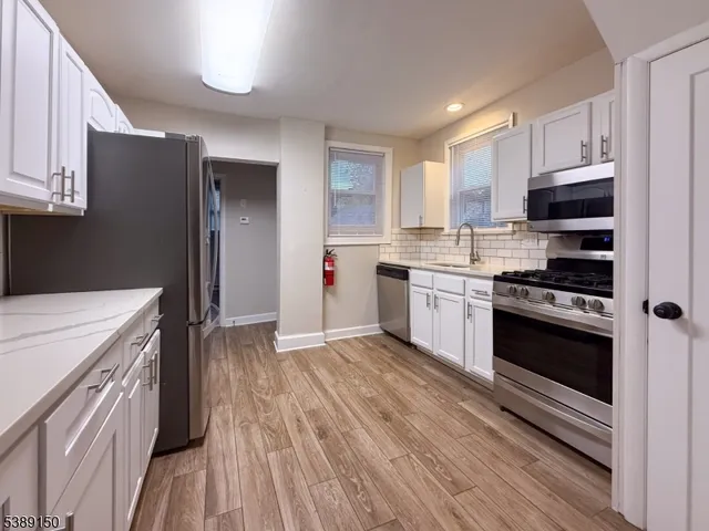 a kitchen with a stove a sink and a refrigerator