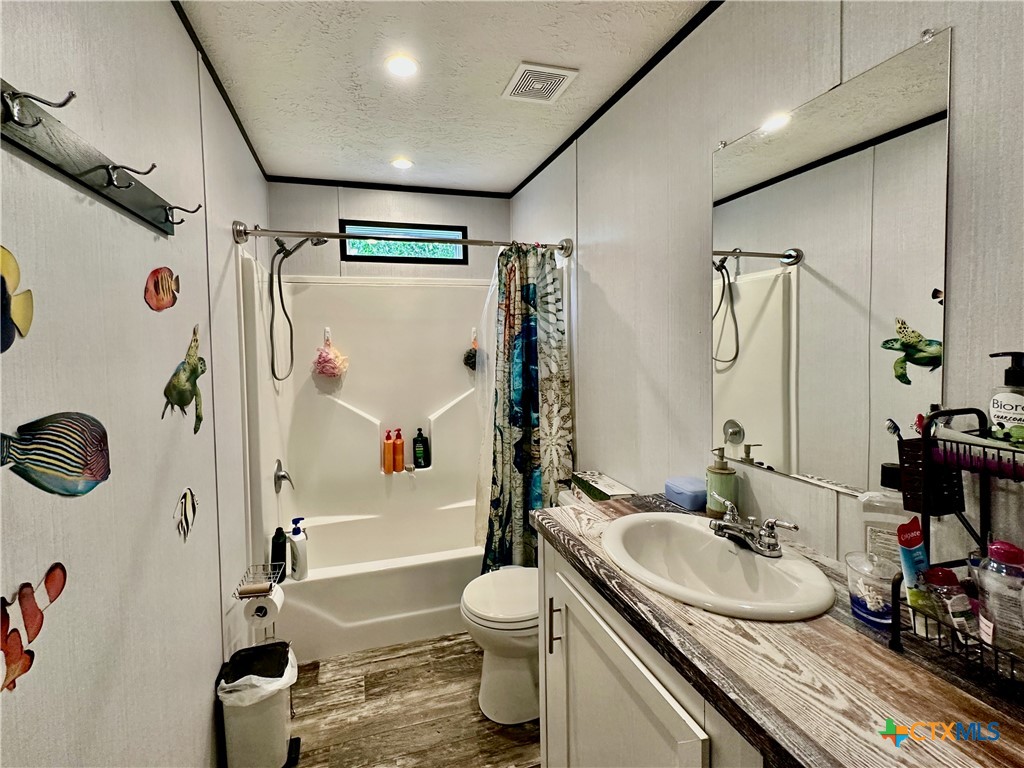 815 Track Road Dale, TX 78616 - Photo 16 of 21 a bathroom with a granite countertop sink toilet and shower