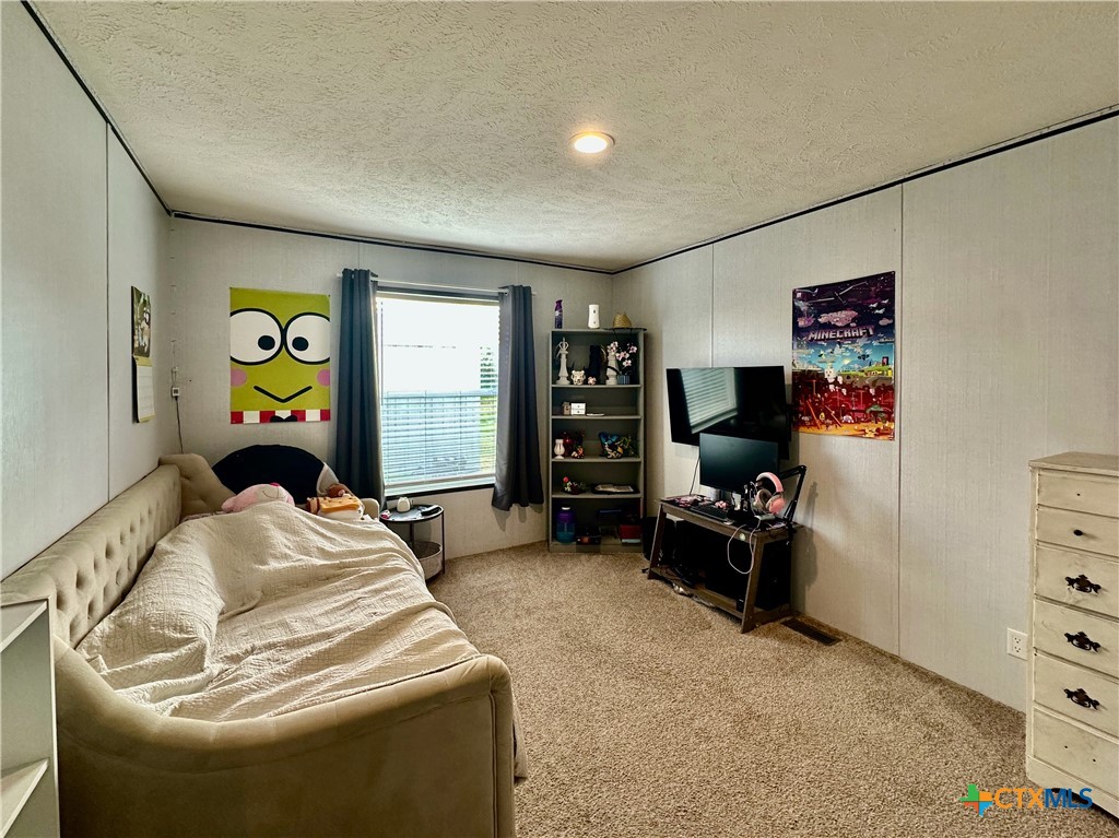 815 Track Road Dale, TX 78616 - Photo 19 of 21 a bedroom with a bed and dresser