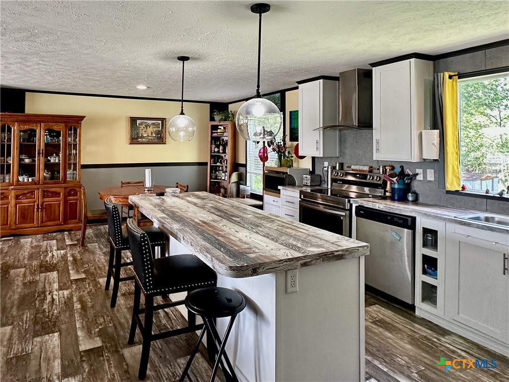 815 Track Road Dale, TX 78616 - Photo 5 of 21 a kitchen with stainless steel appliances granite countertop table chairs sink and cabinets