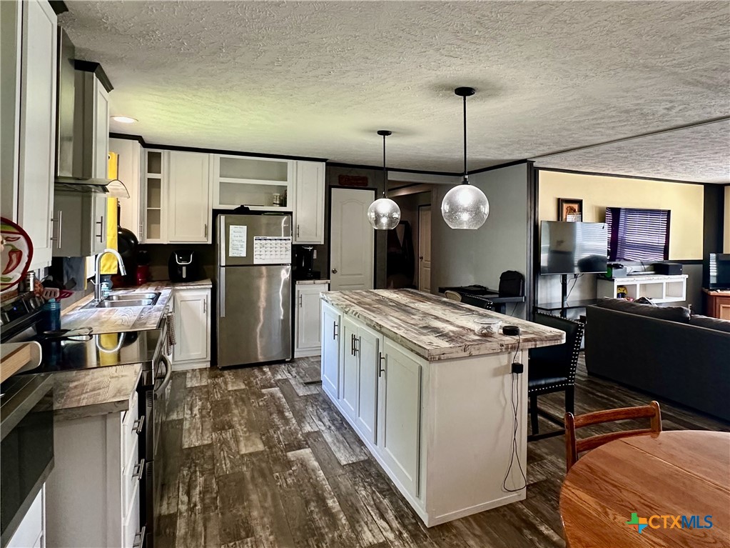 815 Track Road Dale, TX 78616 - Photo 6 of 21 a kitchen that has a lot of cabinets a sink and a stove