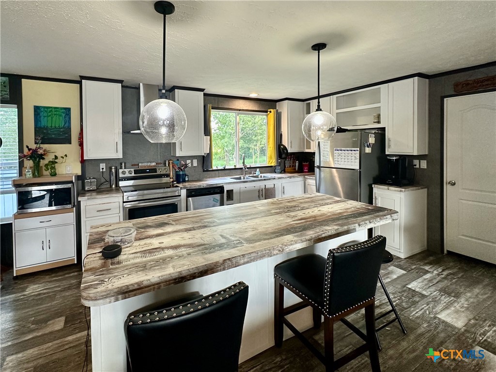 815 Track Road Dale, TX 78616 - Photo 8 of 21 a kitchen with kitchen island a counter space a sink appliances and cabinets