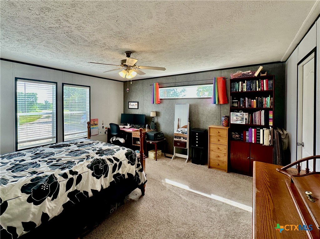 815 Track Road Dale, TX 78616 - Photo 9 of 21 a bedroom with furniture and a book shelf