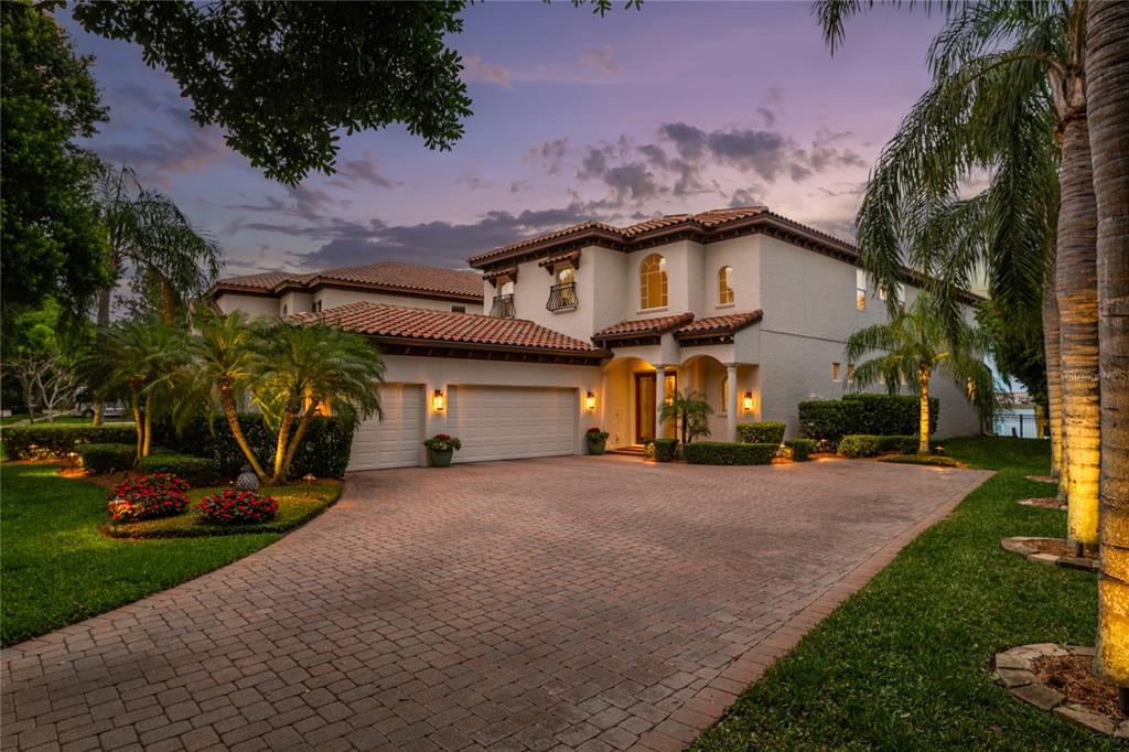 a view of a house with a yard and pathway