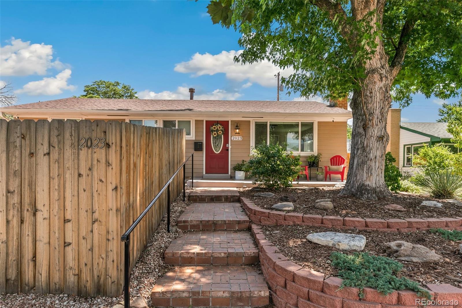a backyard of a house with yard table and chairs