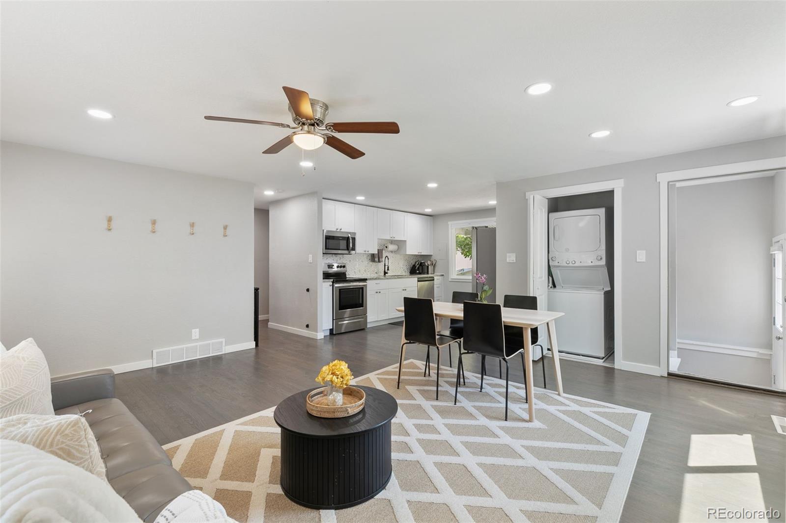 2023 Winston Road Colorado Springs, CO 80909 - Photo 17 of 39 a living room with furniture a rug and kitchen view