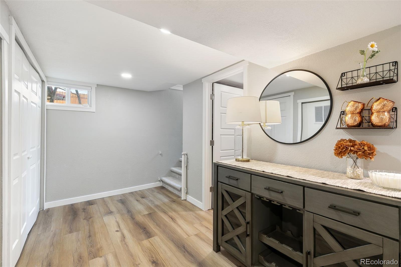 2023 Winston Road Colorado Springs, CO 80909 - Photo 19 of 39 a view of a kitchen with cabinets and a wooden floor
