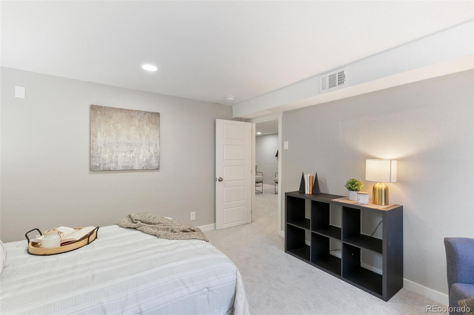 2023 Winston Road Colorado Springs, CO 80909 - Photo 23 of 39 a bedroom with a bed and a window
