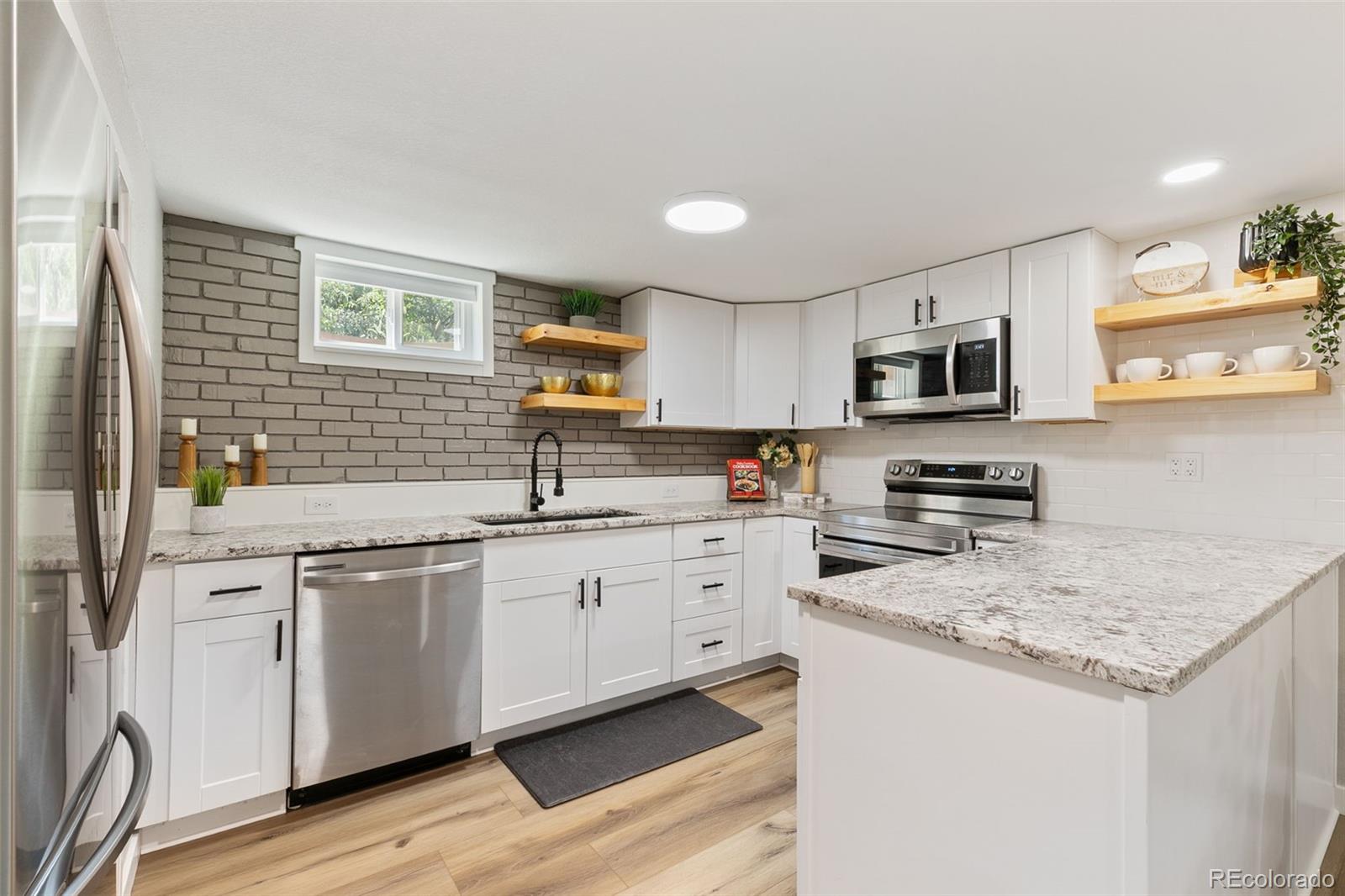 2023 Winston Road Colorado Springs, CO 80909 - Photo 25 of 39 a kitchen with sink cabinets and microwave