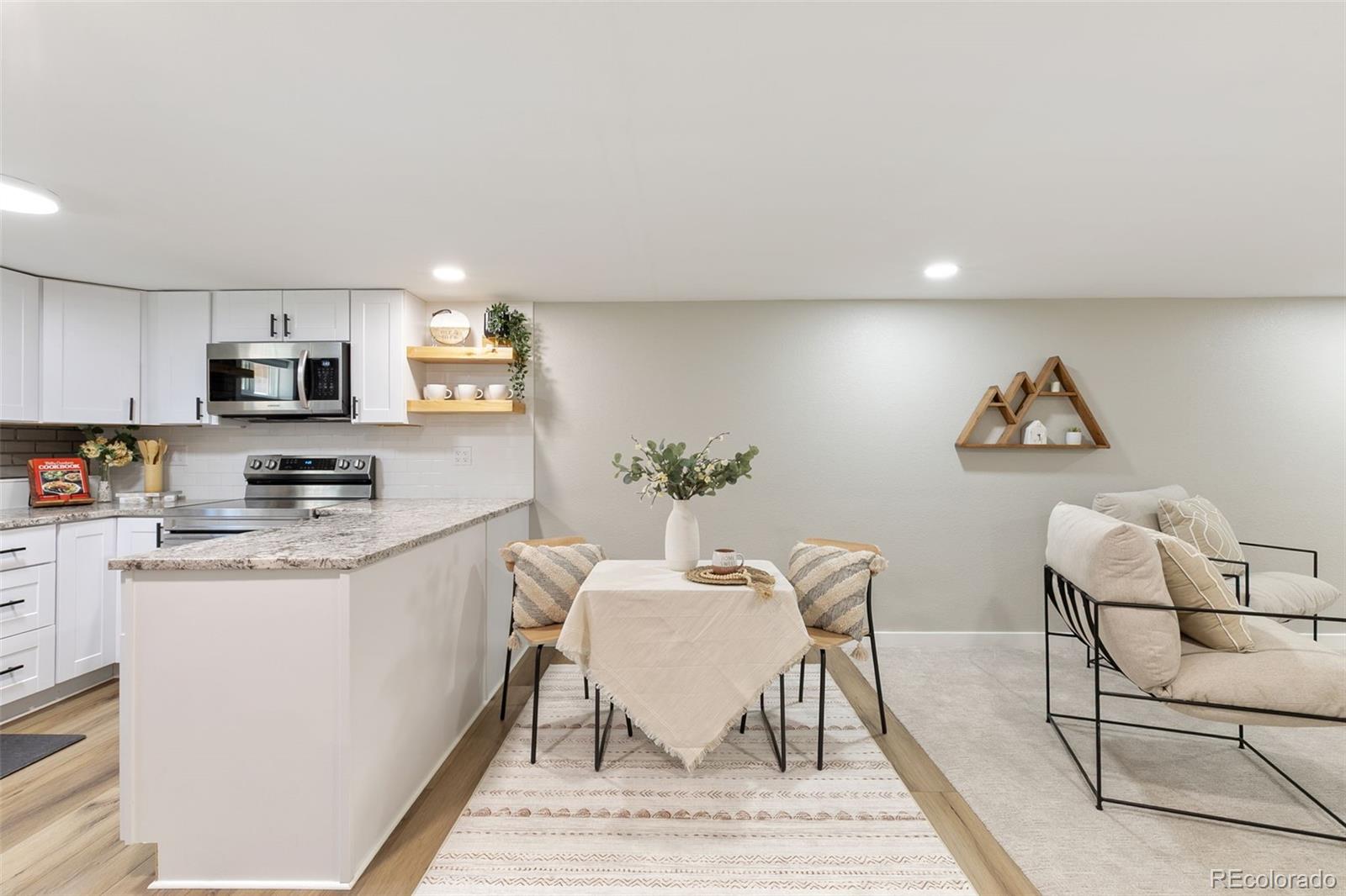 2023 Winston Road Colorado Springs, CO 80909 - Photo 27 of 39 a view of kitchen with microwave stove top oven and cabinets