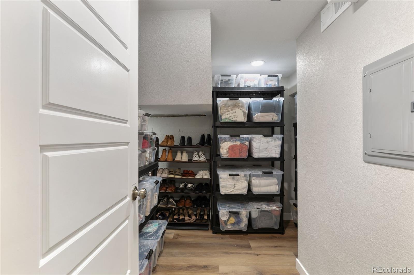 2023 Winston Road Colorado Springs, CO 80909 - Photo 28 of 39 a view of walk in closet with clothes and shoes