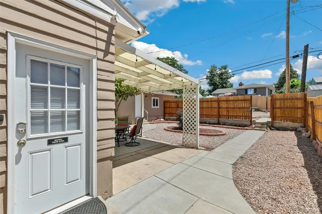 a view of a porch with furniture and cars parked