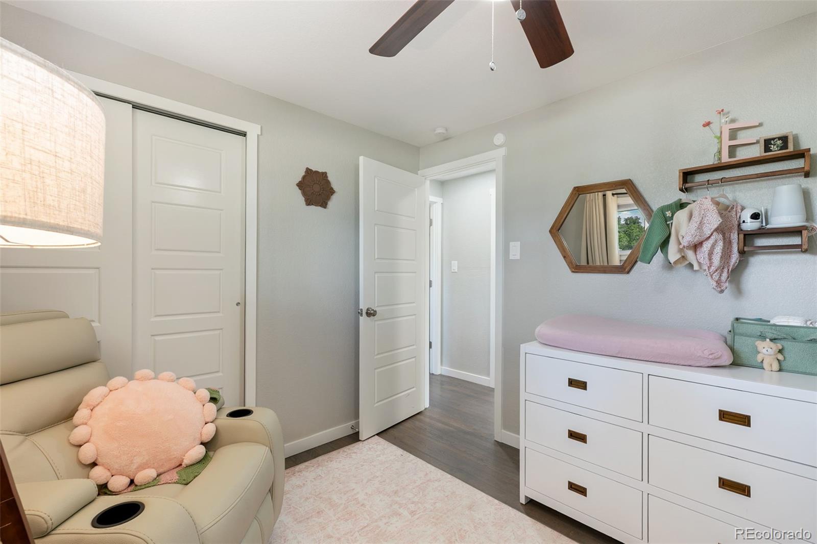 2023 Winston Road Colorado Springs, CO 80909 - Photo 10 of 39 a bedroom with a bed and a mirror