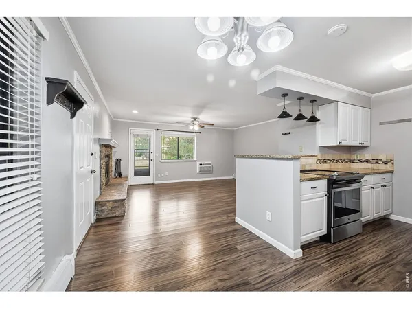 a kitchen with granite countertop a stove a sink dishwasher and a refrigerator