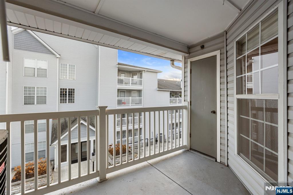690 Rt 23, Unit 1349 Wayne, NJ 07470 - Photo 11 of 11 a view of balcony with a floor to ceiling window and wooden floor