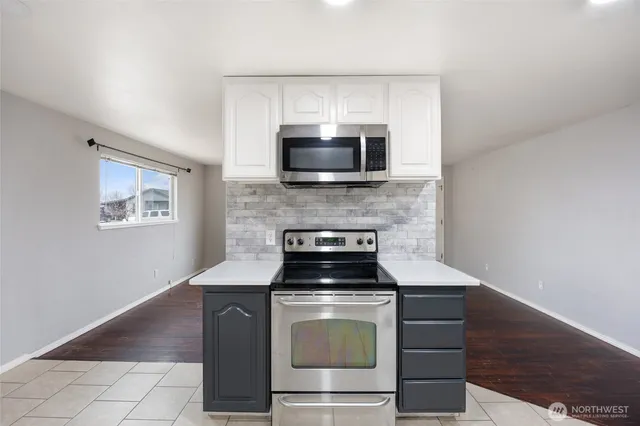 a kitchen with a stove and a microwave