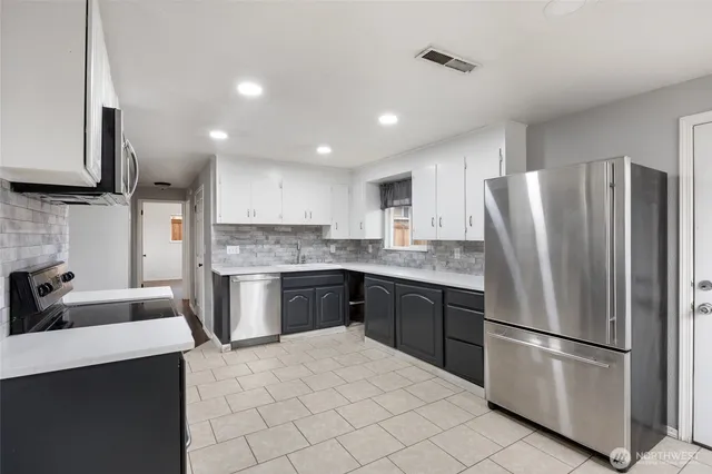 a kitchen with a refrigerator sink and microwave
