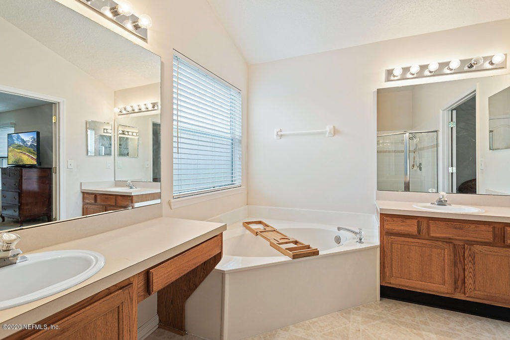 2443 Paris Mill Road Jacksonville, FL 32221 - Photo 21 of 33 a bathroom with a sink and a mirror