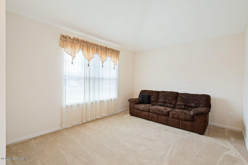 2443 Paris Mill Road Jacksonville, FL 32221 - Photo 6 of 33 a living room with furniture and a window