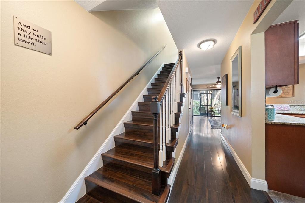 2131 Ridge Road South, Unit 75 Largo, FL 33778 - Photo 15 of 32 a view of a hallway with wooden floor and staircase