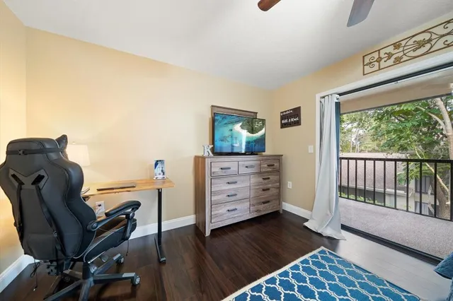 a bathroom with a granite countertop sink mirror vanity and toilet