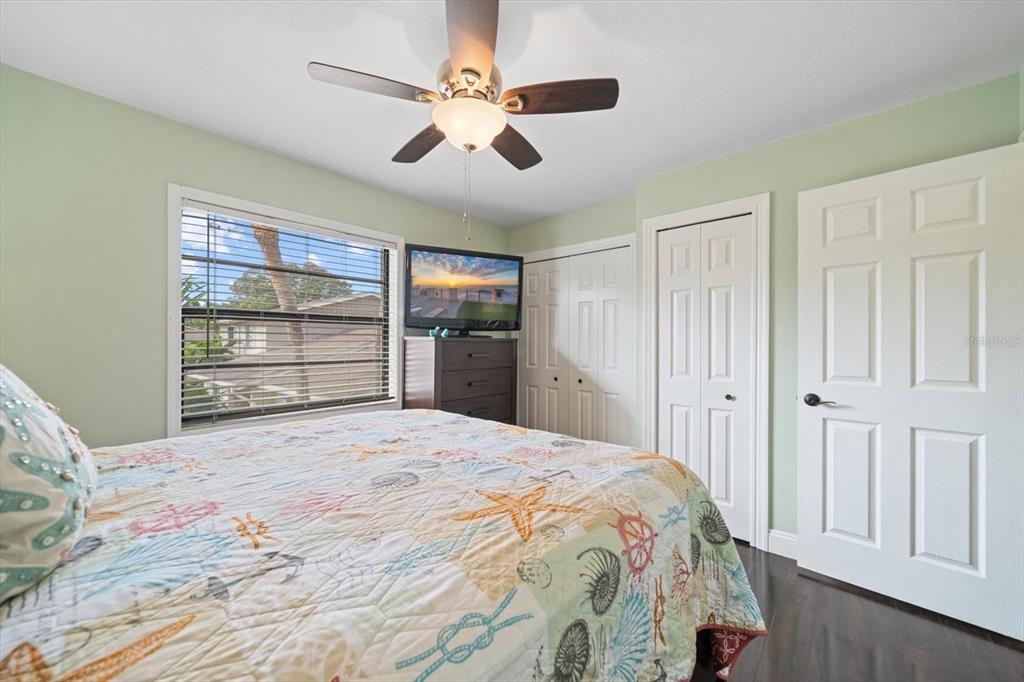 2131 Ridge Road South, Unit 75 Largo, FL 33778 - Photo 23 of 32 a bedroom with a bed and closet with wooden floor