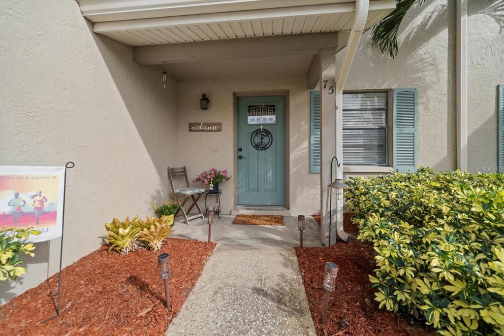 2131 Ridge Road South, Unit 75 Largo, FL 33778 - Photo 31 of 32 a front view of a house with outdoor seating