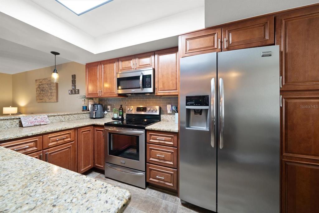 2131 Ridge Road South, Unit 75 Largo, FL 33778 - Photo 4 of 32 a kitchen with a refrigerator sink and stainless steel appliances