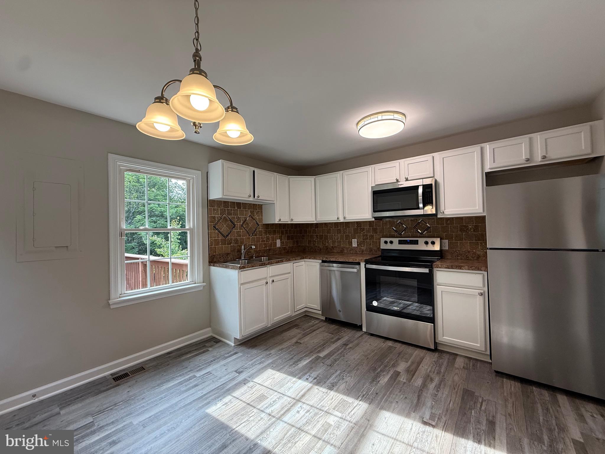 319 Chopping Road Mineral, VA 23117 - Photo 7 of 22 a kitchen with stainless steel appliances granite countertop a refrigerator a stove a microwave and cabinets