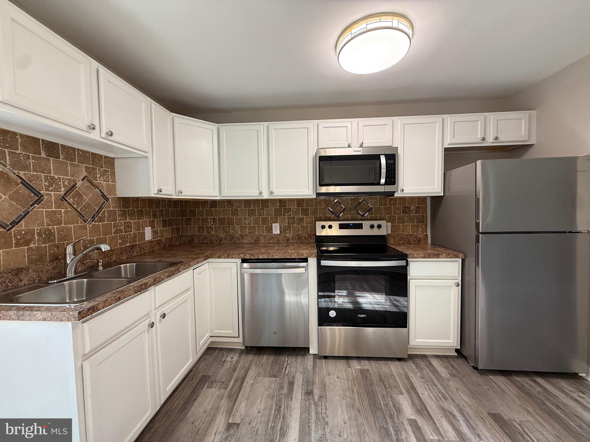 319 Chopping Road Mineral, VA 23117 - Photo 8 of 22 a kitchen with a refrigerator stove and microwave