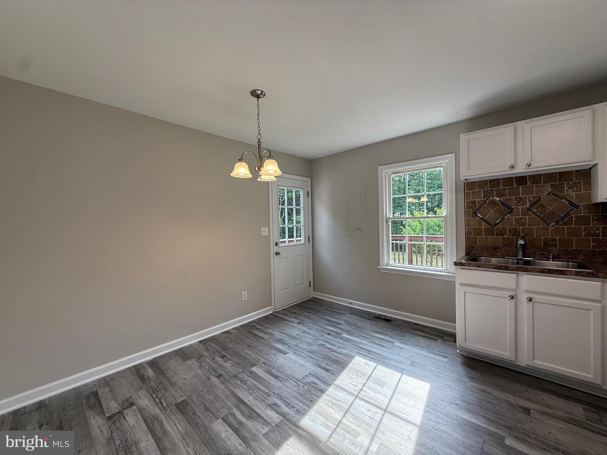 319 Chopping Road Mineral, VA 23117 - Photo 9 of 22 a view of an empty room with window and wooden floor