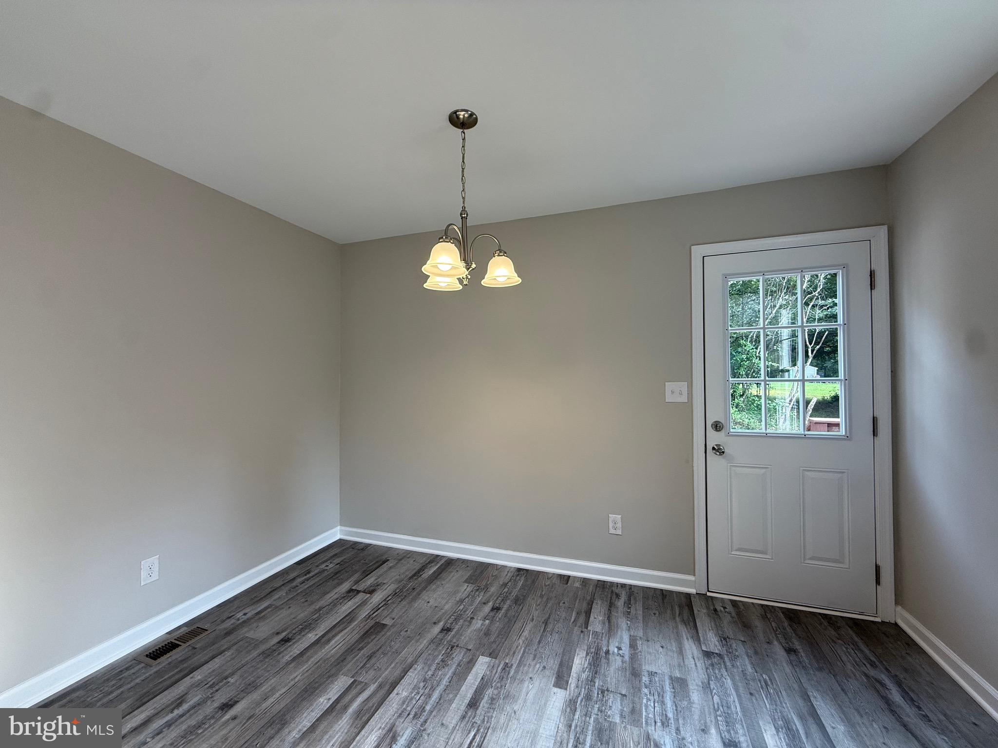 319 Chopping Road Mineral, VA 23117 - Photo 10 of 22 a view of an empty room with wooden floor and a window
