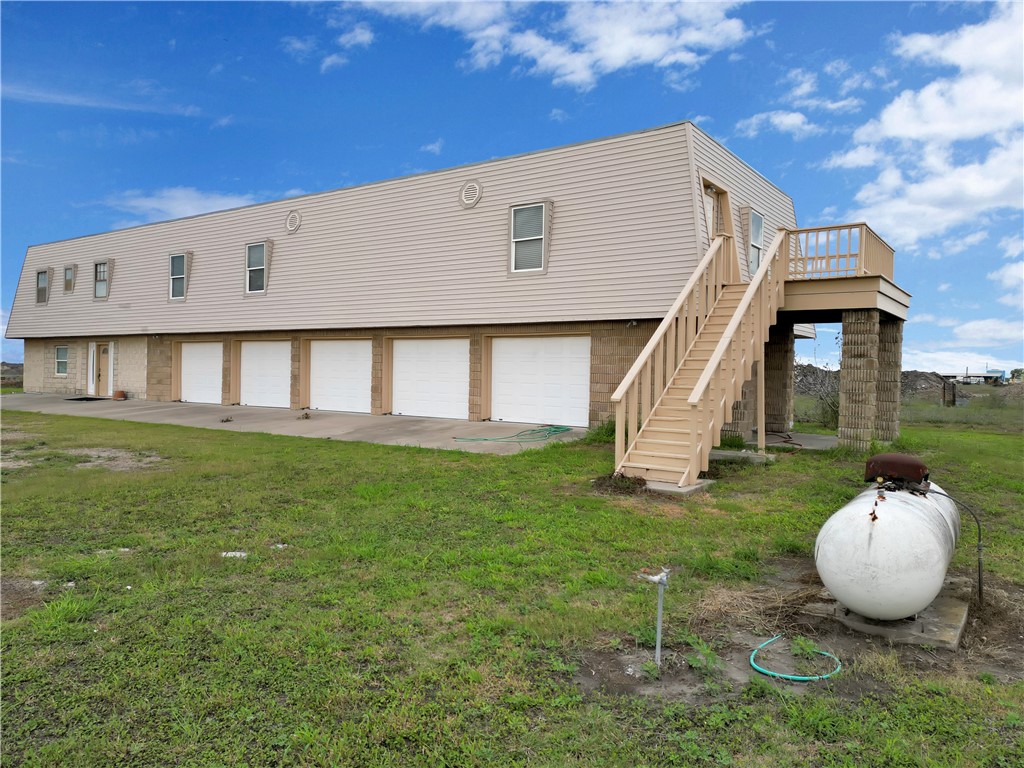 2977 Jurica Road Corpus Christi, TX 78415 - Photo 16 of 40 a front view of a house with a garden