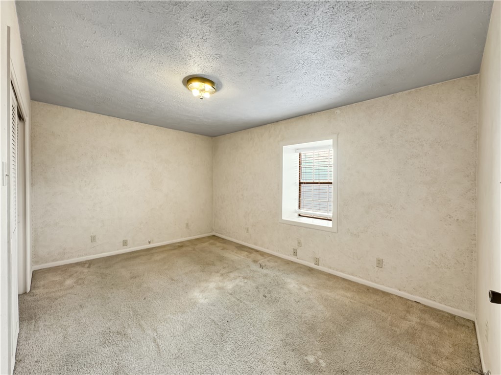 2977 Jurica Road Corpus Christi, TX 78415 - Photo 32 of 40 an empty room with a empty space and windows