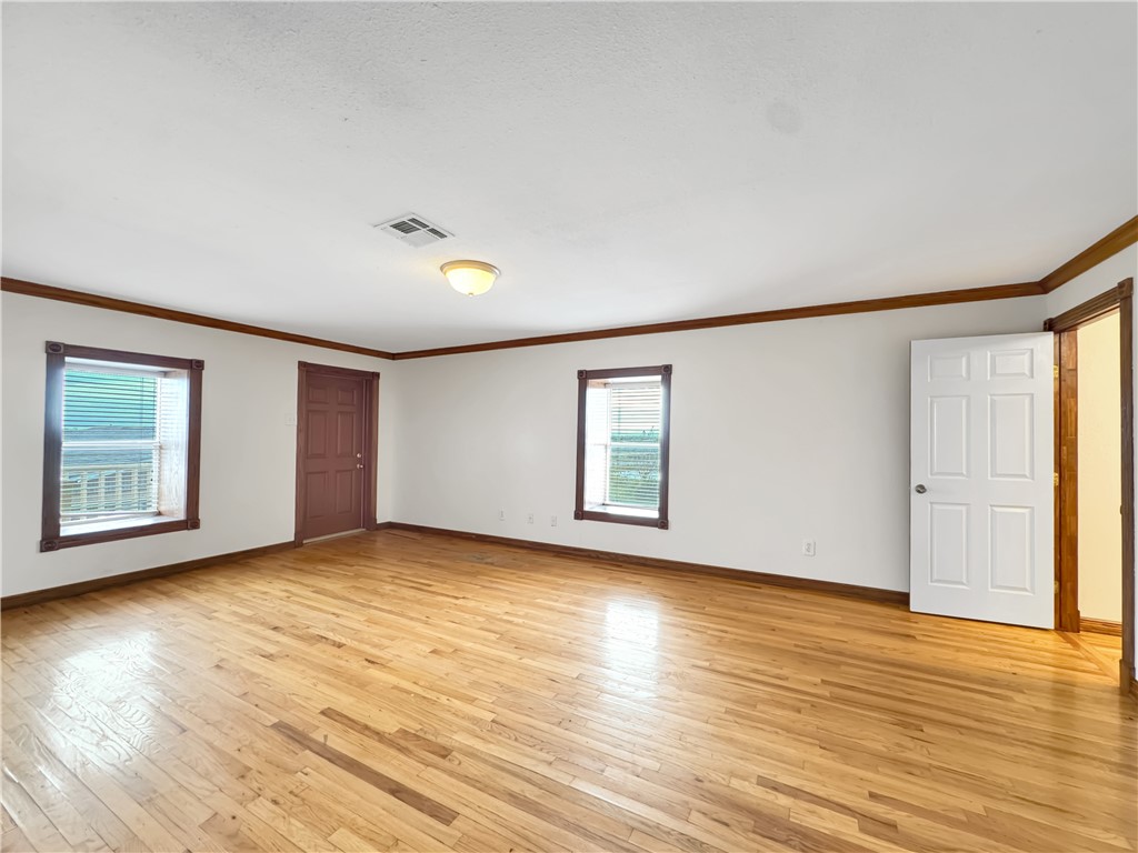 2977 Jurica Road Corpus Christi, TX 78415 - Photo 37 of 40 an empty room with wooden floor and windows