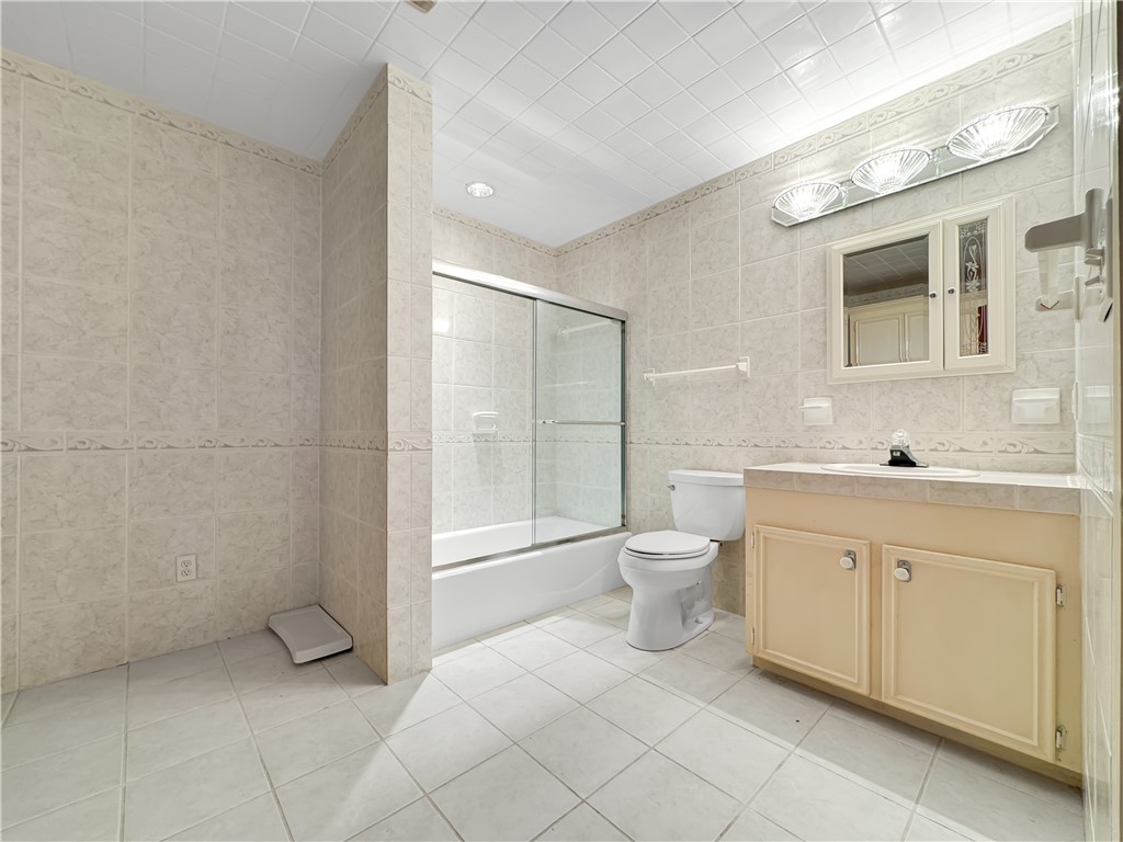 2977 Jurica Road Corpus Christi, TX 78415 - Photo 38 of 40 a bathroom with a toilet sink and shower