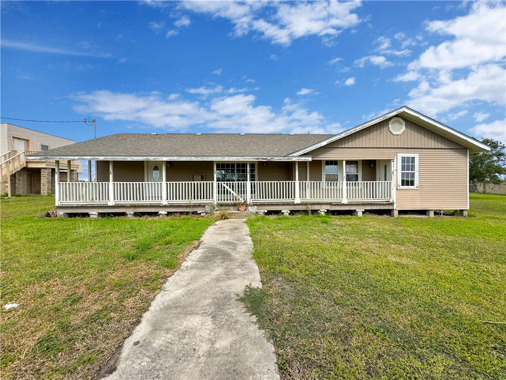 2977 Jurica Road Corpus Christi, TX 78415 - Photo 4 of 40 a front view of a house with a yard table and chairs