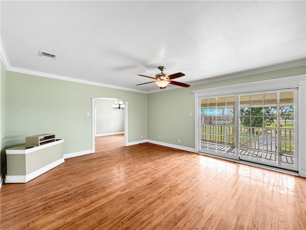 2977 Jurica Road Corpus Christi, TX 78415 - Photo 6 of 40 a view of empty room with wooden floor and fan