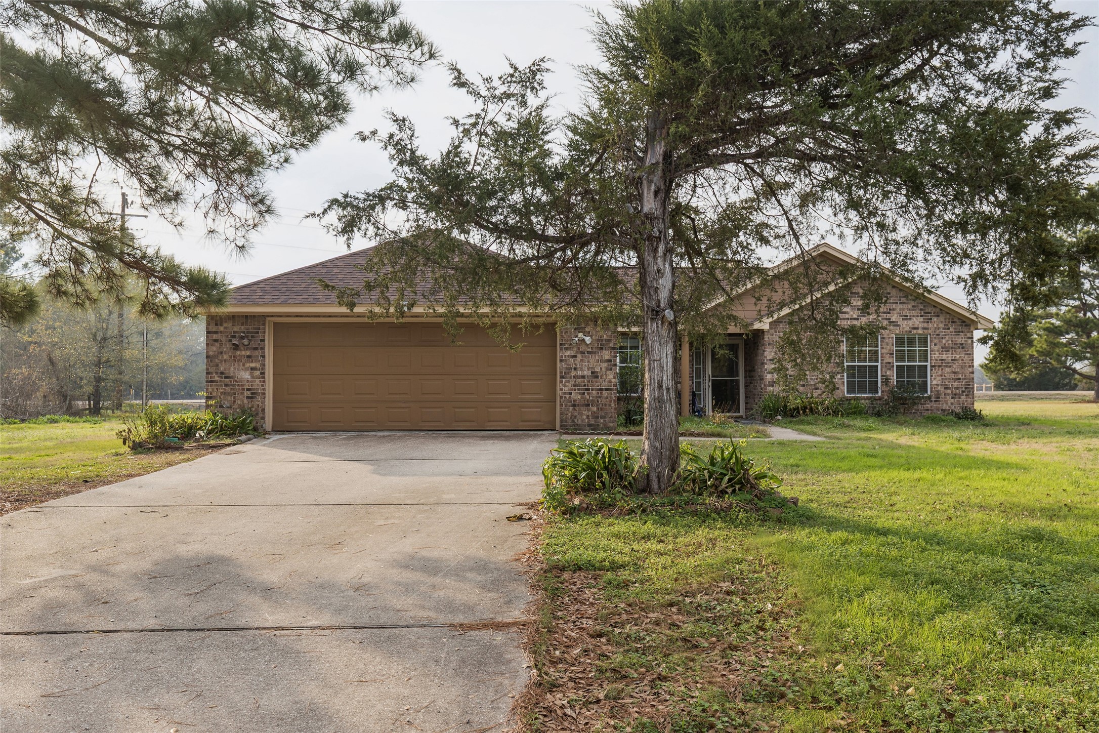 21 Pine Prairie School Road Huntsville, TX 77320 - Photo 1 of 26 a front view of a house with garden