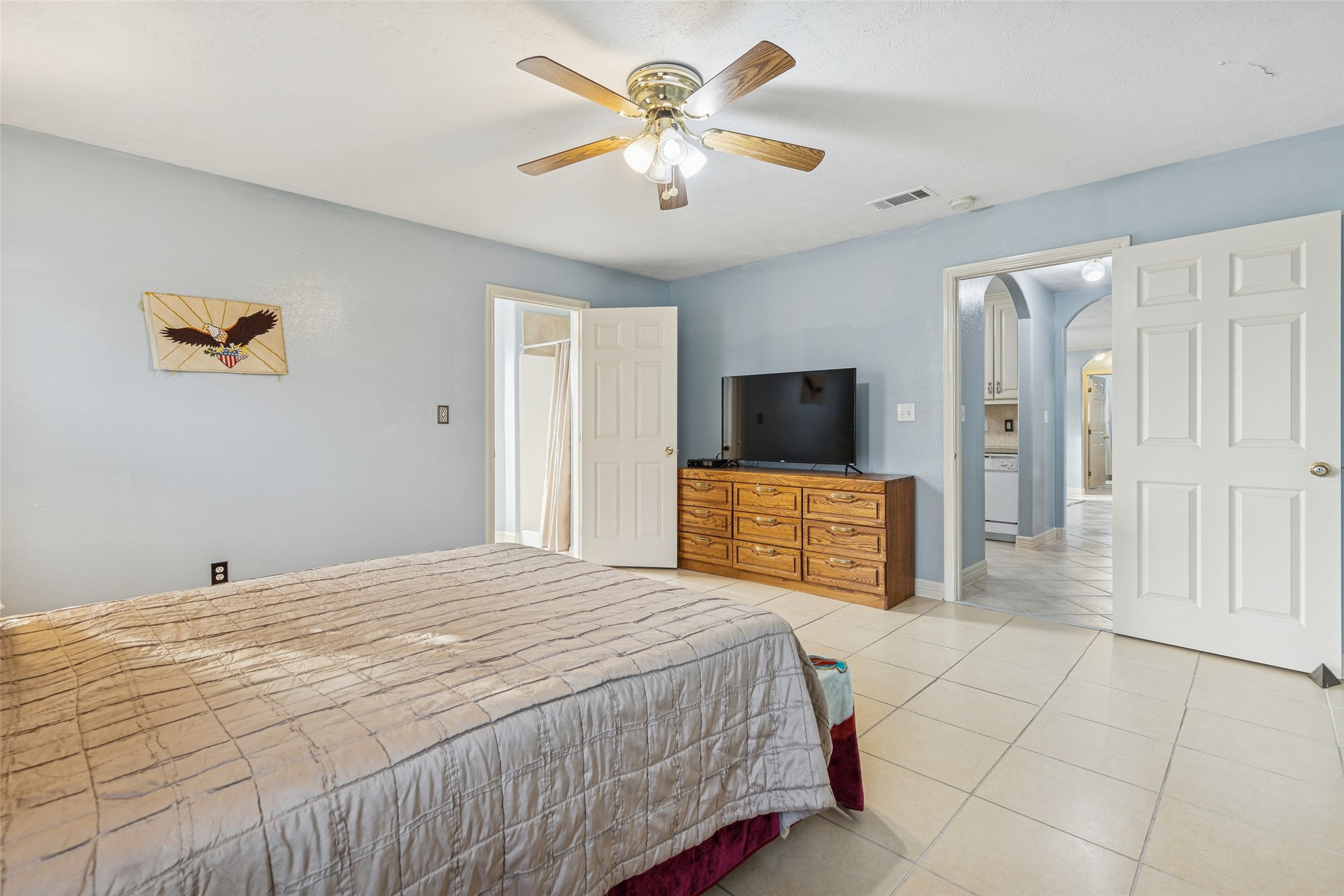 21 Pine Prairie School Road Huntsville, TX 77320 - Photo 15 of 26 a spacious bedroom with a bed and a view of bathroom
