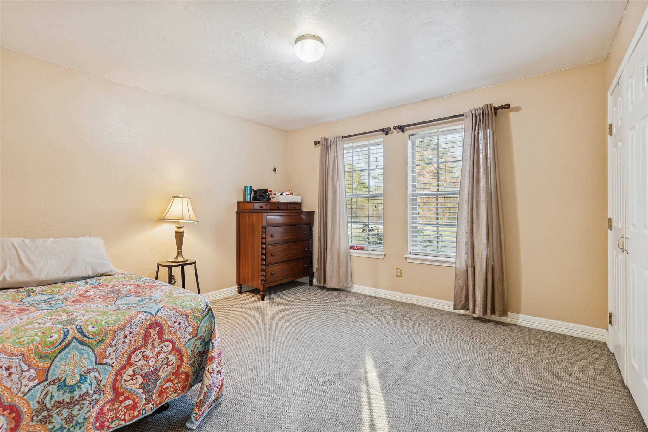 21 Pine Prairie School Road Huntsville, TX 77320 - Photo 19 of 26 a bedroom with a bed and a window
