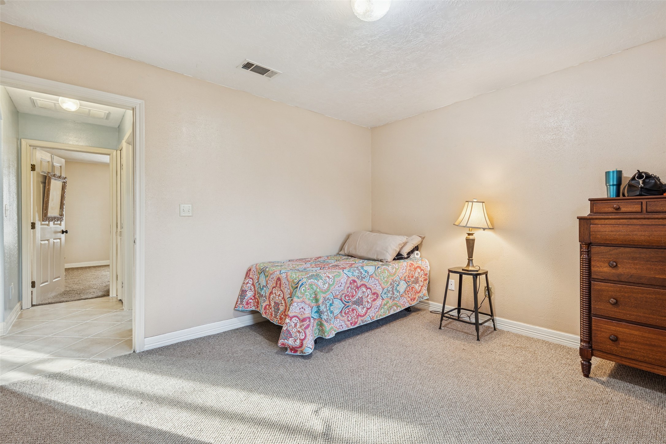 21 Pine Prairie School Road Huntsville, TX 77320 - Photo 20 of 26 a spacious bedroom with a bed and a cabinets