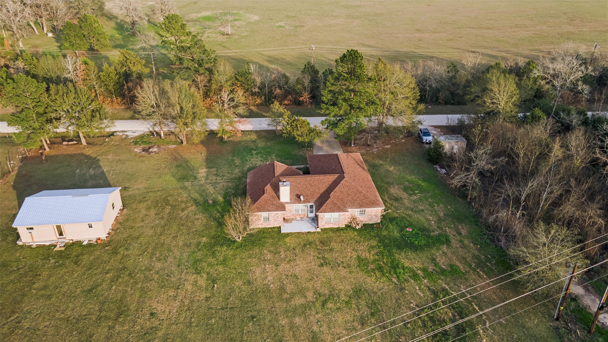 21 Pine Prairie School Road Huntsville, TX 77320 - Photo 25 of 26 an aerial view of a house with a yard and lake view