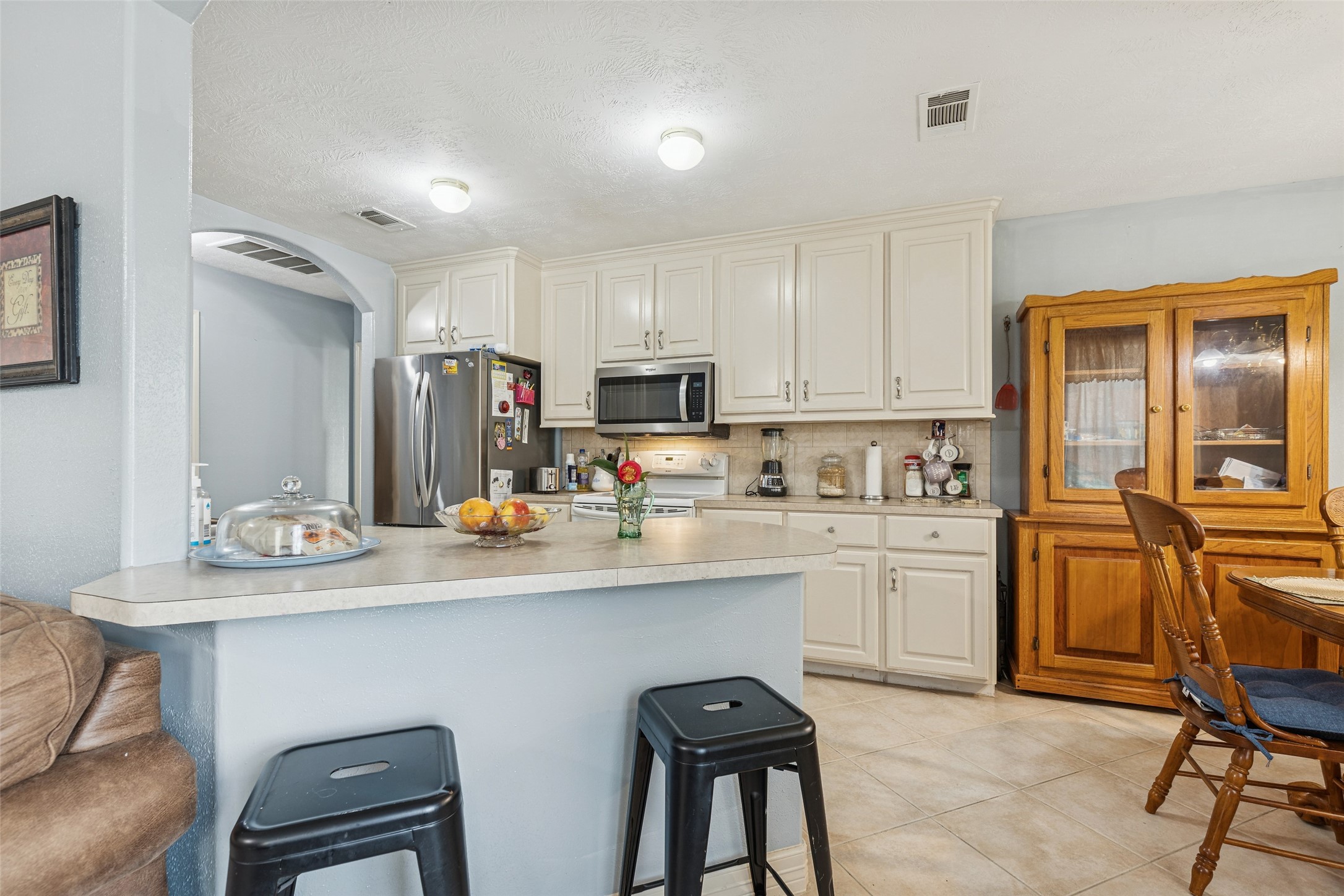 21 Pine Prairie School Road Huntsville, TX 77320 - Photo 10 of 26 a kitchen with cabinets a sink and chairs