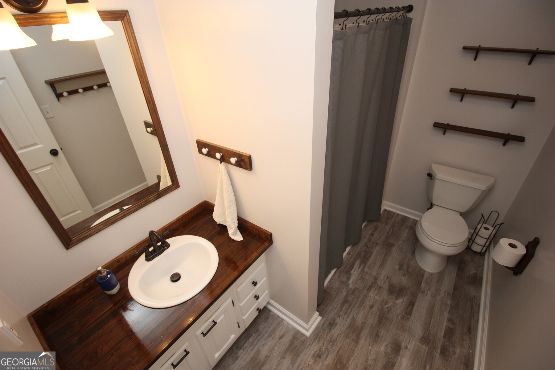 231 Murphy Road LaGrange, GA 30240 - Photo 21 of 24 a bathroom with a sink mirror and toilet