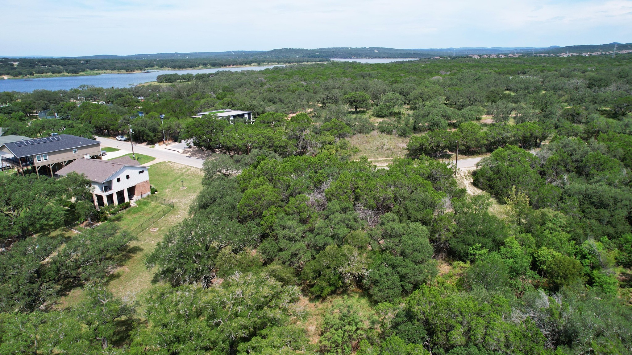 6719 Bar K Ranch Road Lago Vista, TX 78645 - Photo 2 of 36 a view of a city with lush green forest