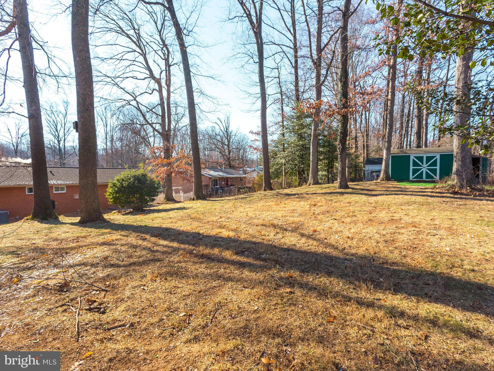 8702 Victoria Road Springfield, VA 22151 - Photo 24 of 27 a house with trees in front of it