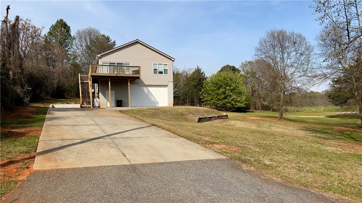 160 Hudgins Lake Road Townville, SC 29689 - Photo 41 of 41 A split-level residence is set amidst a verdant landscape, offering a serene backdrop.
