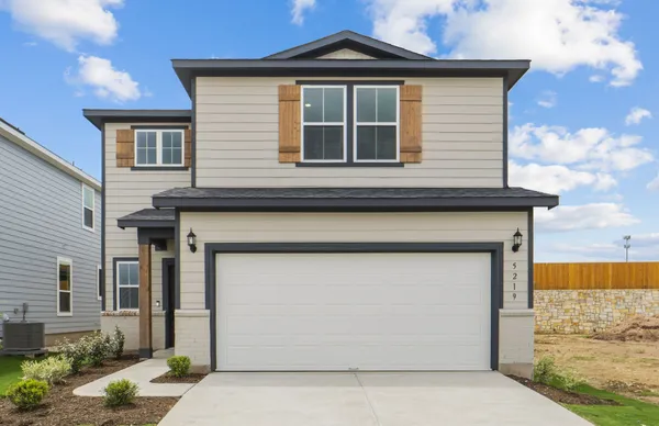 a front view of a house with garage