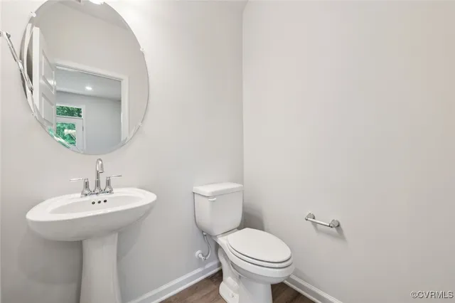 a bathroom with a sink toilet and a mirror